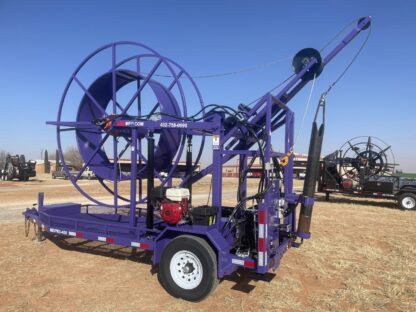 Purple industrial cable spool trailer outdoors.