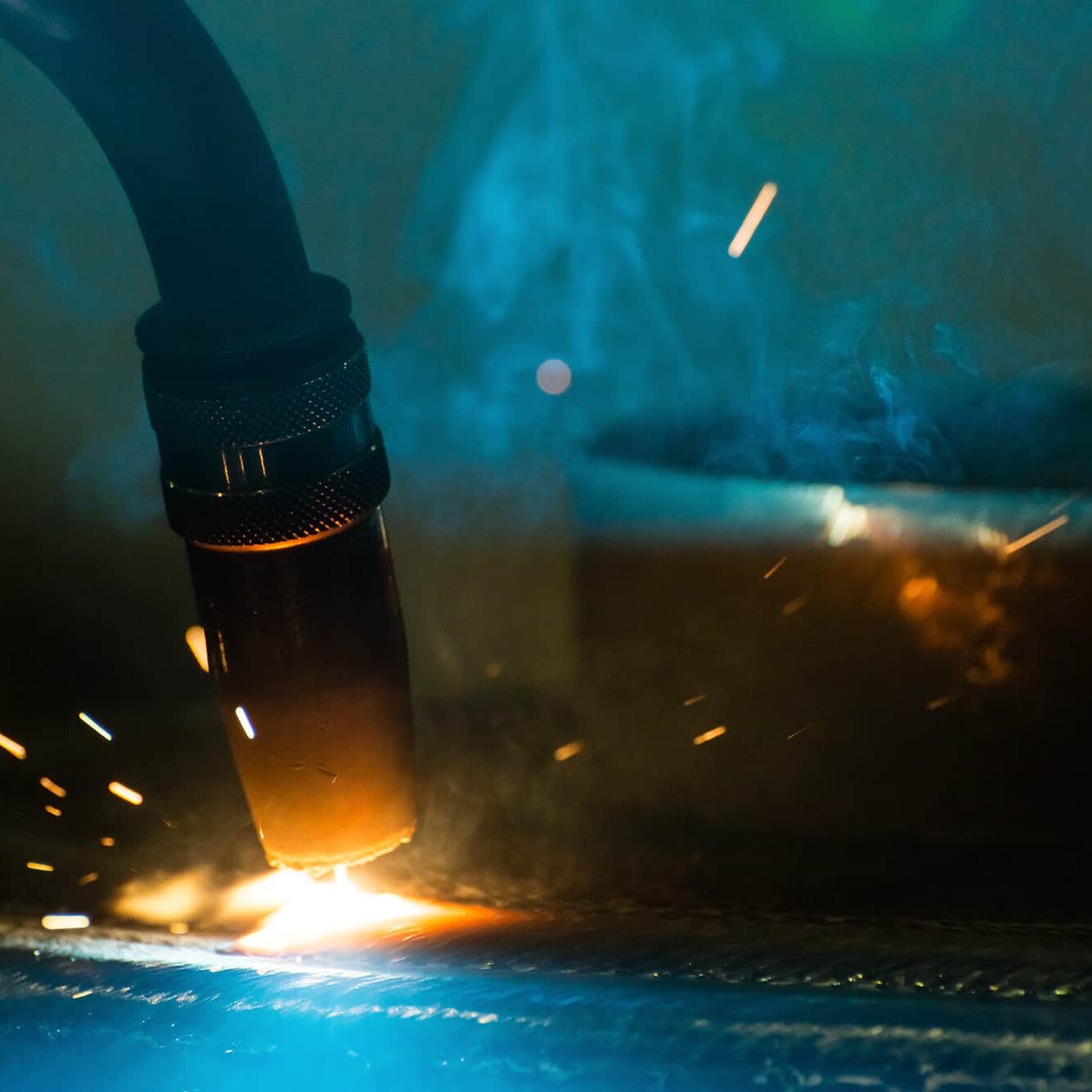 A picture of a welding process with sparks flying.